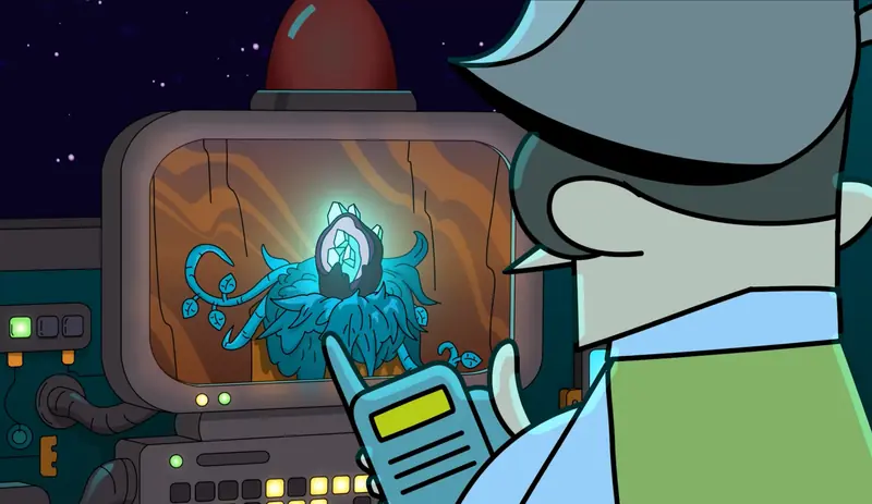 A hand holds a scanner up to a console screen showing a glowing blue creature